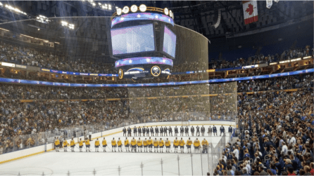 Sabres prospects await play during the anthems in front of nearly 17,000 fans. 