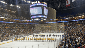 Sabres prospects await play during the anthems in front of nearly 17,000 fans. 